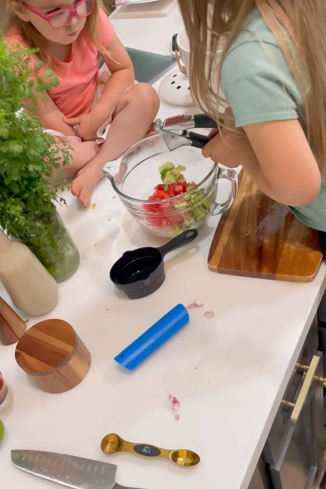 Using a garlic press to finely dice garlic for ceviche recipe. 